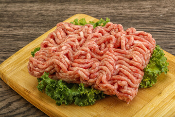 Raw pork minced meat over board