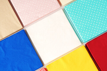 Colorful square paper napkins background top view