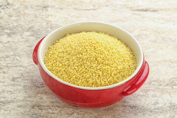 Raw couscous in the bowl