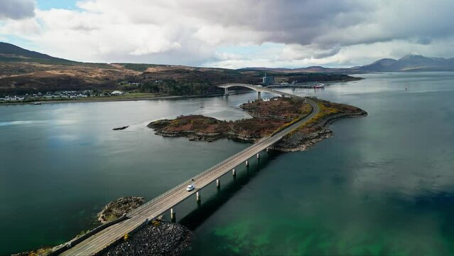 Drone descends above Skye bridge in Scotland as cars commute between island and mainland