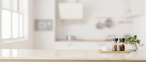 Space on a luxury white kitchen countertop with a blurred background of a modern white kitchen.