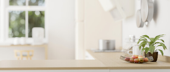 Empty mockup space on a wooden kitchen countertop in a modern bright kitchen. close-up image