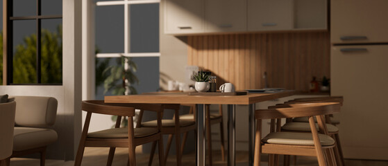 Fototapeta na wymiar A modern minimal wooden dining table with armchairs in a spacious modern Scandinavian kitchen.