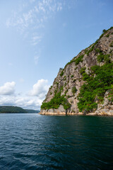 Fototapeta na wymiar Steep cliffs off a mountain into a deep fjord.