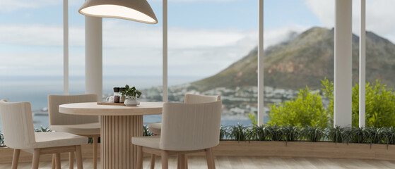 A modern dining room with a dining table near the window with a beautiful stunning coast view.