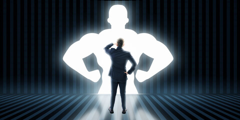 Back view of businessman with very strong illuminated shadow flexing muscles on dark wall...