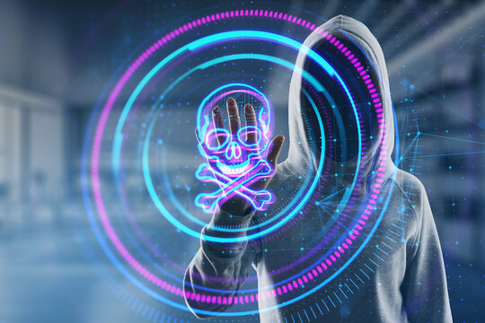 Hacker in hoodie using creative digital round skull hologram on blurry office interior background. Hacking, piracy and malware concept. Double exposure.