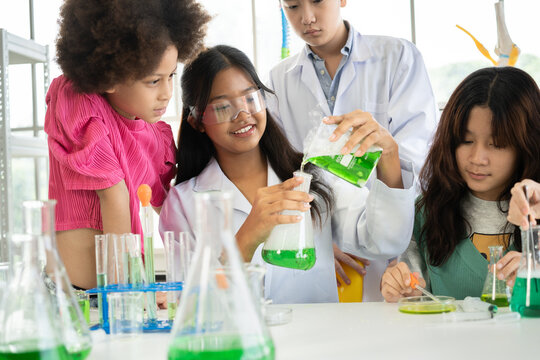 Asia and mix race Kid girl funny learning study science of test chemical at learning class	