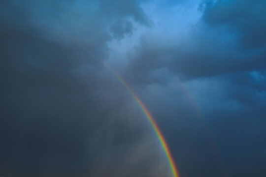 Bright rainbow in overcast sky