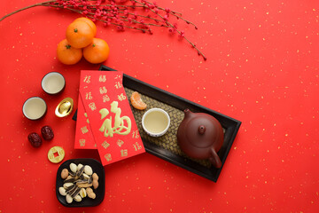 Kung Fu tea, snacks, fruits, ingots, and red envelopes on a red background. The meaning of the text...