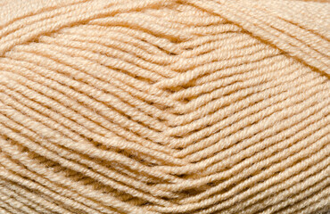 The texture of beige wool blend yarn.