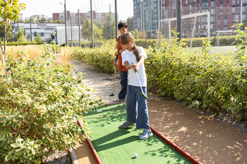 Kids playing golf inside playground artificial grass activity game for children 