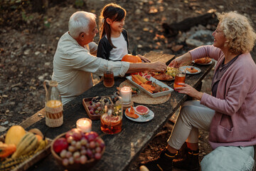 Family having a picnic and eating in the forest