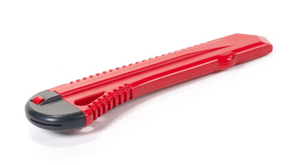Red stationery knife with a blade isolated on a white background