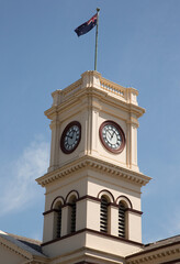 Clock tower of the historic post office (built 1876-1877) flying the Australian flag in Maryborough, Victoria, Australia.