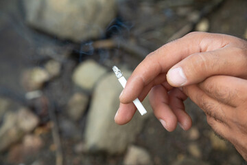 Caucasian man smoking a cigarette.