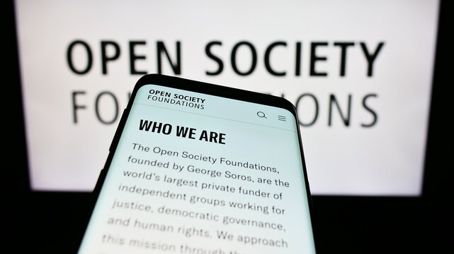 Stuttgart, Germany - 10-09-2023: Mobile phone with webpage of organization Open Society Foundations (OSF) in front of logo. Focus on top-left of phone display.