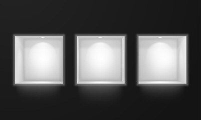Niches in the wall with lighting on a dark background.