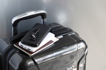 Power bank and passport on luggage for travel of holiday - obrazy, fototapety, plakaty