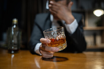 Businessman wearing a suit whiskey glass of liquor.