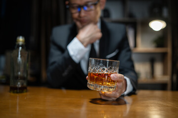 Businessman wearing a suit whiskey glass of liquor.