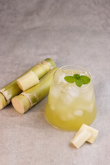 Es Tebu or Fresh Squeezed Sugar Cane Juice with Fresh Sugar Cane.