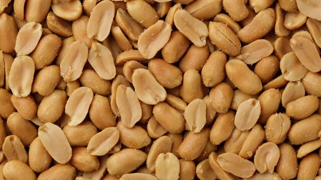 Zoom frame salted roasted peanuts top view, rotate