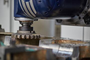 vertical milling machine close-up processes a part in production, modern equipment for metal processing