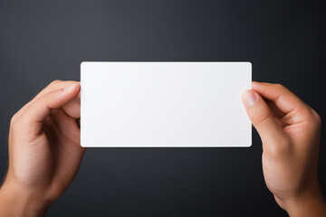A woman holding an empty card from her both hands in a minimalist isolated copy space background, Hand hold empty white card mockup, Business branding minimal mock