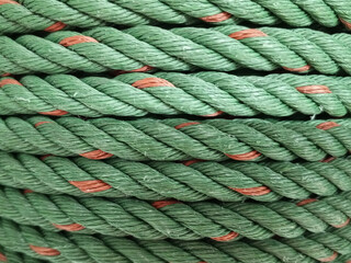 Texture of a coil of polypropylene green rope , Green Rope Background