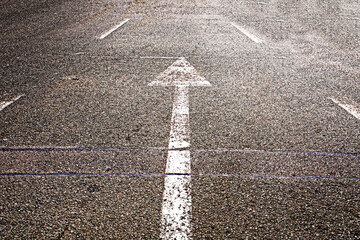 white arrows pointers on the asphalt highway