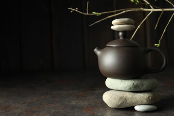 Asian tea concept, teapot on dark background.