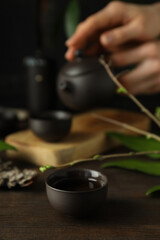 The concept of Asian tea, on a dark background with plants.