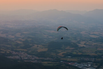 paraglider in the mountains, sunset flight
