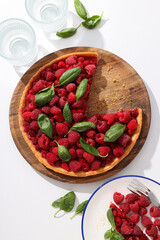 Berry pie, plates and glasses on white background, top view
