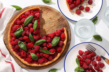 Berry pie, plates and glasses on white background, top view