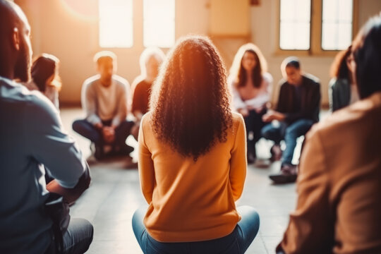 Group of people sitting in circle talking and supporting each other. Support group session, talking openly and feeling hopeful and happy.