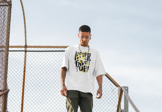 Mockup of young man wearing customizable t-shirt in urban setting