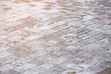 Salt stains on pedestrian paving slabs, salting sidewalk during winter. Salty surface, salt on...