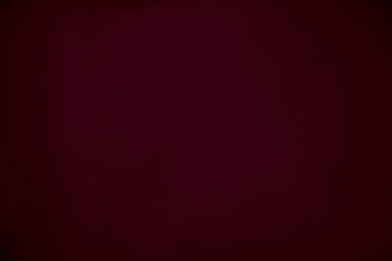 Gradient  dark red silk fabric texture used as background. red panne fabric background of soft and...