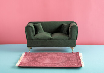 Green furniture and carpet on pink and blue background.