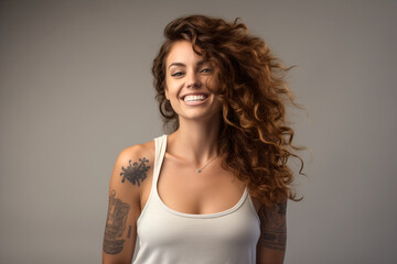 young happy pretty smiling girl beautiful female portrait, model, beautiful face, medium short curly hair, healthy skin, tattoos, wearing white top, white undershirt