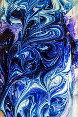 Wavy multi-colored patterns and stains from paint close-up in a plastic bottle	
