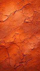 Fototapeta premium the dry arid earthy cracked background is an iron rich dry clay that is orange in color.