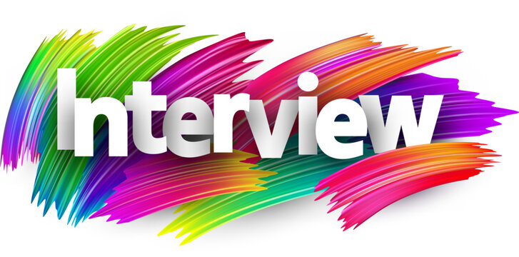 Interview paper word sign with colorful spectrum paint brush strokes over white.