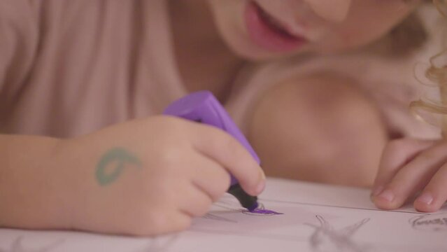 young child using coloured pen