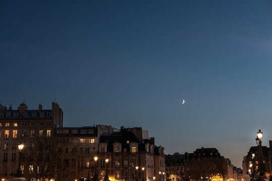 Toits de Paris la nuit avec la lune
