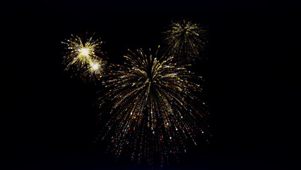 Christmas fireworks. Explosions of flying multi-colored particles on a blue background. 3D render.