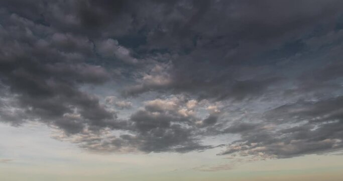 Timelapse dark storm clouds dramatic black sky background. Dark clouds before thunder storm coming. Meteorology danger windstorm climate. Dark cloudscape storm disaster timelapse gloomy gray sky.