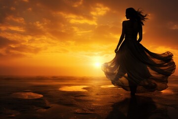 Fototapeta na wymiar A stunning bride, her dress flowing in the breeze, walks along the sandy beach as the sky transforms into a fiery sunset, the clouds above reflecting in the calm waters below
